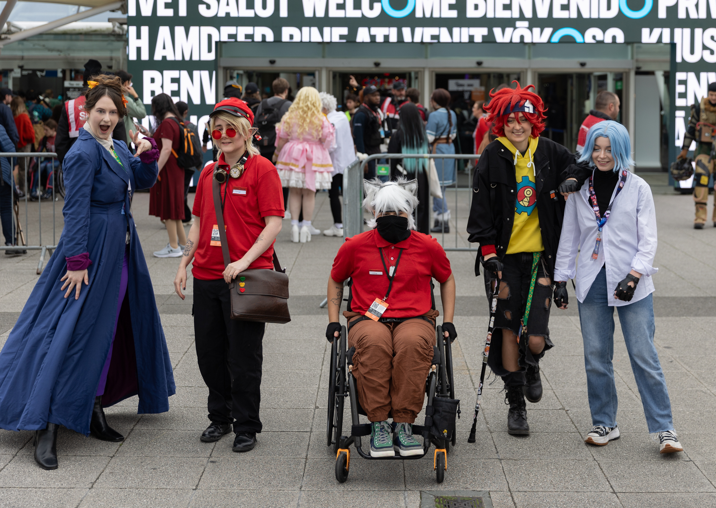 Visitors at Comic Con, one guest in a wheelchair and one using a crutch